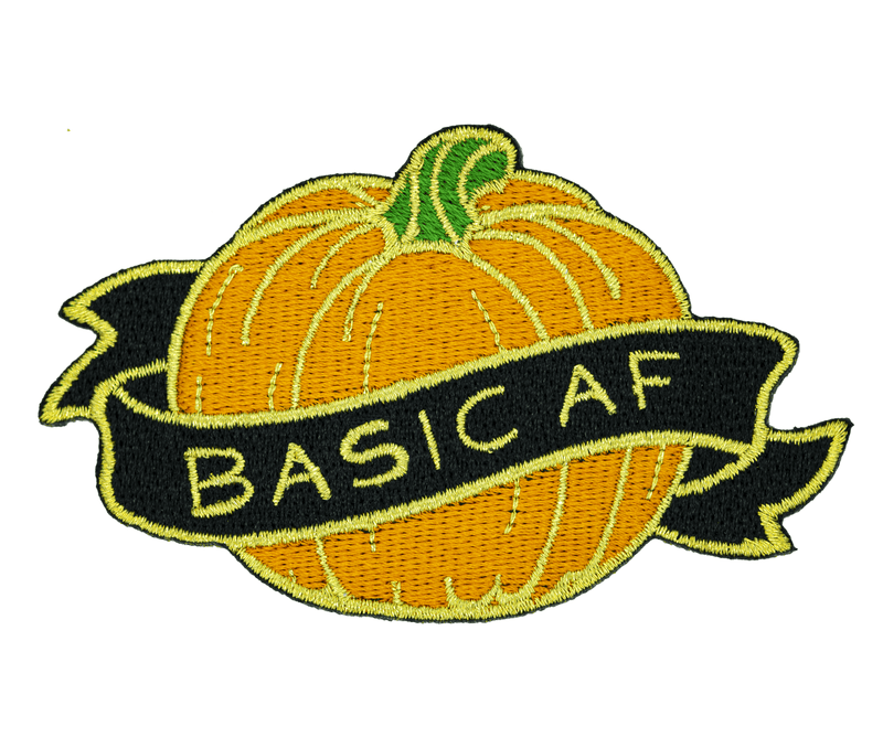 An embroidered iron-on patch of an orange pumpkin, surrounded by a black and gold banner which reads "BASIC AF".