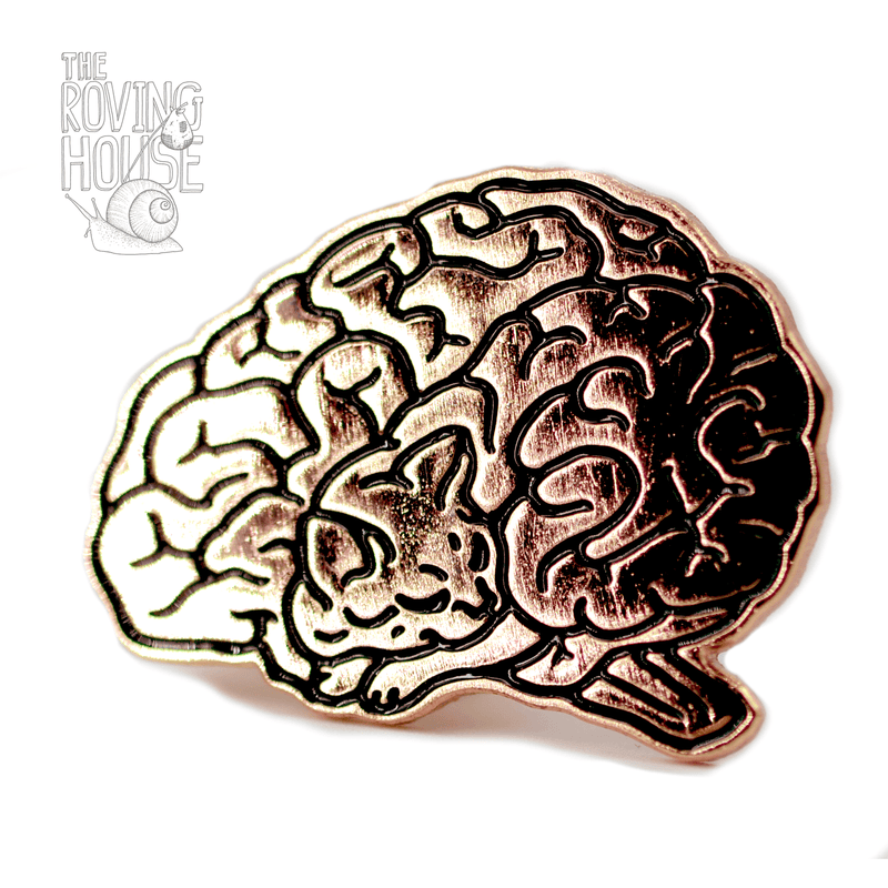 A rose gold metal and enamel pin in the shape of a human brain. Upon closer inspection, the lines of the brain resemble a sleeping cat.