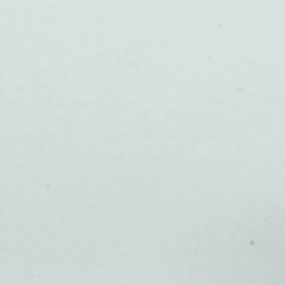 A closeup video of a man stamping on white paper, leaving the line art of a small stylized skull.