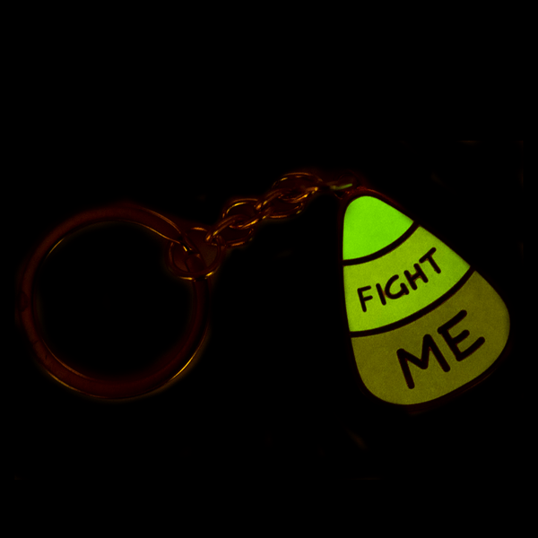 The candy corn keychain glowing greenish, with the lights off.