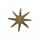 A gold metal sun-with-a-face pin, with antique artwork from the Flammarion Engraving.