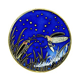 An enamel pin featuring two Big Dipper fireflies meeting under the night sky. 