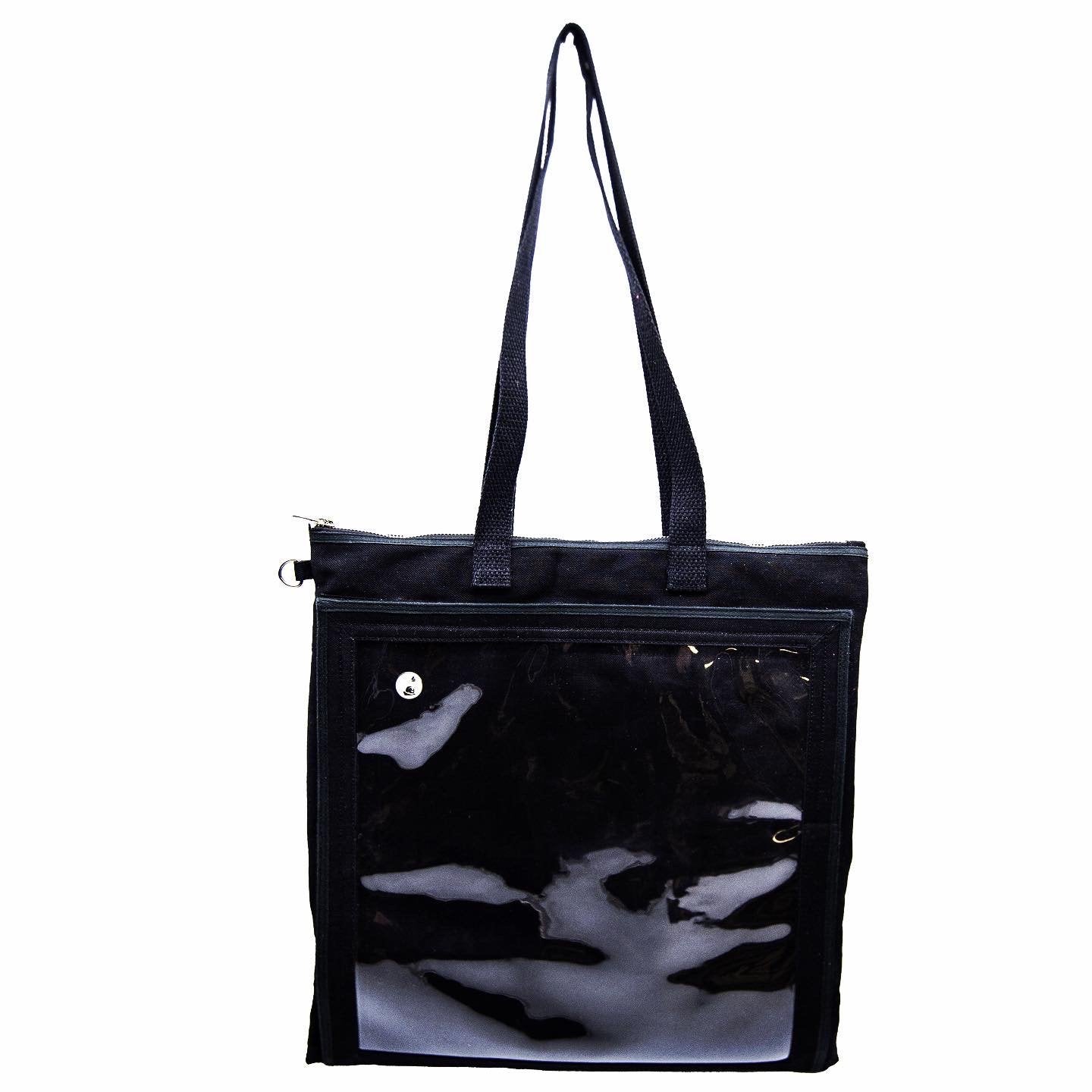 A black canvas Ita tote showing only one enamel pin inside. The tote is big enough to hold vinyl records, a jacket, or a change of clothes.