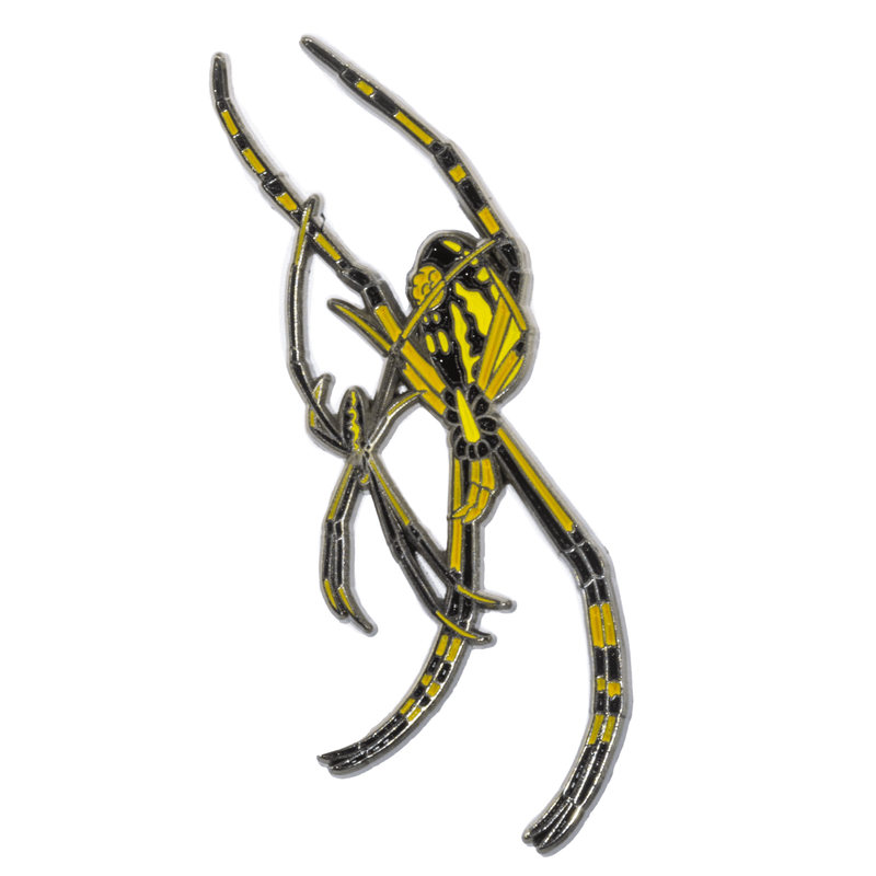 A soft enamel pin of a male and female yellow garden spider.