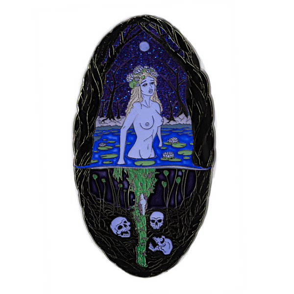 A large enamel pin of a mythological Rusalka in a swamp during the night time, with the full moon overhead. Above the water, she appears as a young, blonde, pale woman wearing water lilies in her hair. Below the water, her legs are green and zombie-like, and three skulls surround her feet. The sky glitters blue and purple.