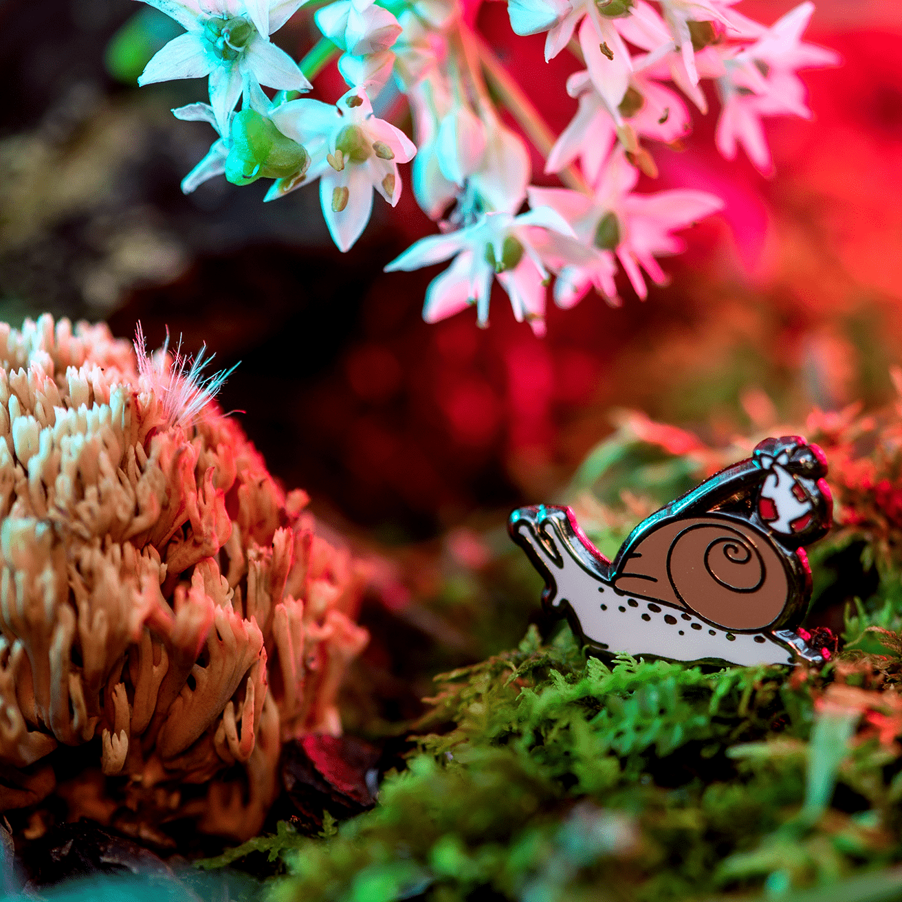 Rover the Snail Mini Pin by The Roving House, featuring a hobo or runaway snail with a bindle exploring moss, mushrooms, and garlic flowers.