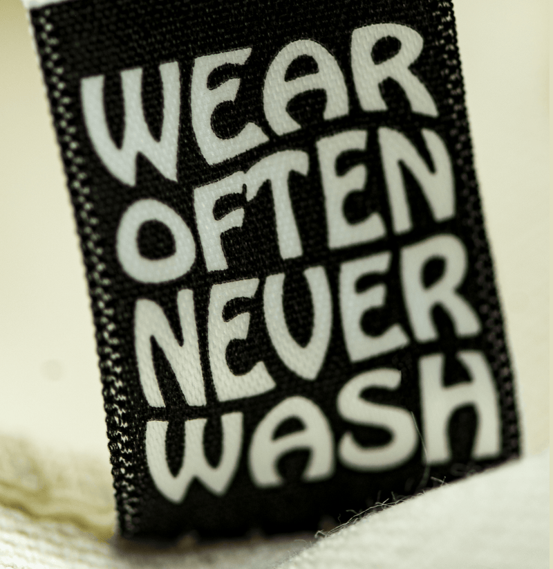 The reverse side of the tag with care instructions, which say "Wear often, never wash".