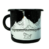 A black enamel and metal camp mug. The all-white design features a snail carrying a bindle across a snowy winter landscape, with pine trees, icy mountains, and a starry night sky in the background.